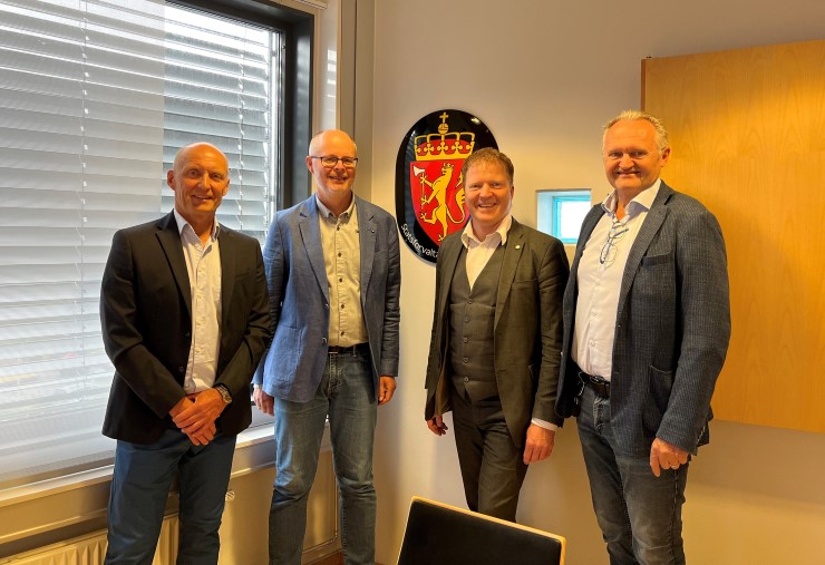 Seniorrådgjevar Kåre Træen, kommunaldirektør Nils Erling Yndesdal, kommunal- og distriktsminister Sigbjørn Gjelsvik og fungerande statsforvaltar Christian Rekkedal.