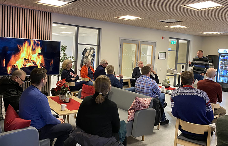 Mann som snakker til en gruppe mennesker
